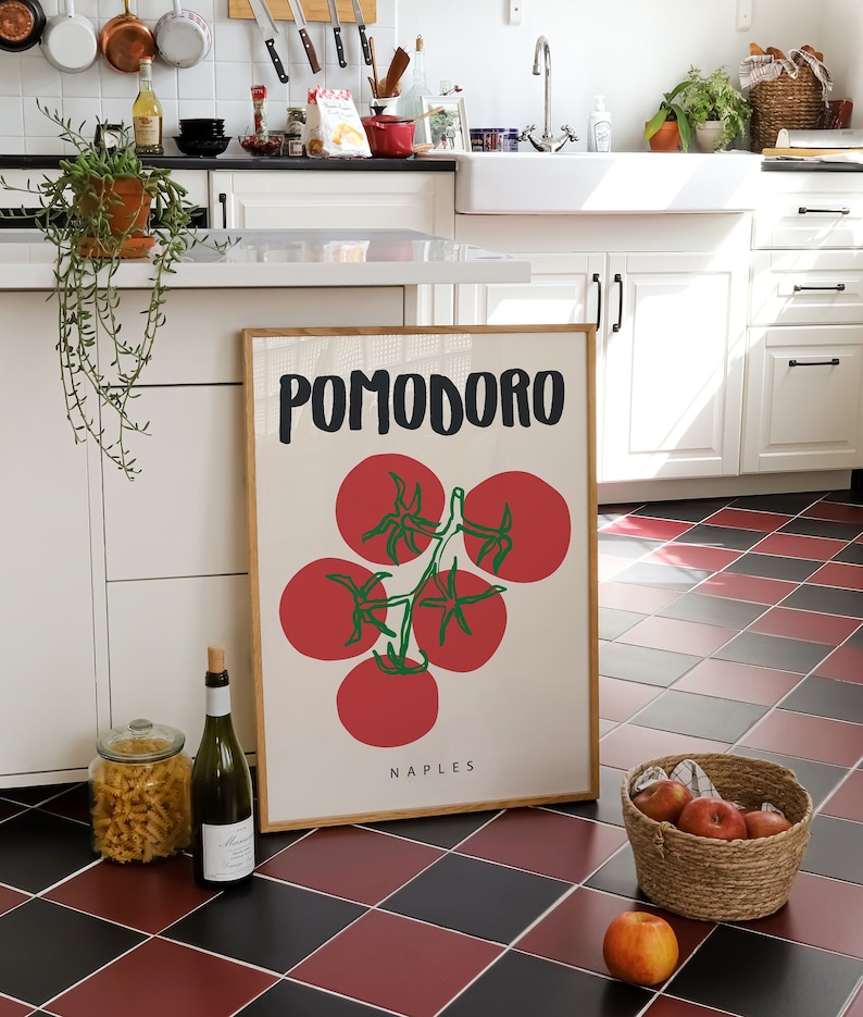 May include: A framed print with a white background and black text that reads "POMODORO NAPLES". The print features a stylized illustration of a red tomato vine with green leaves.