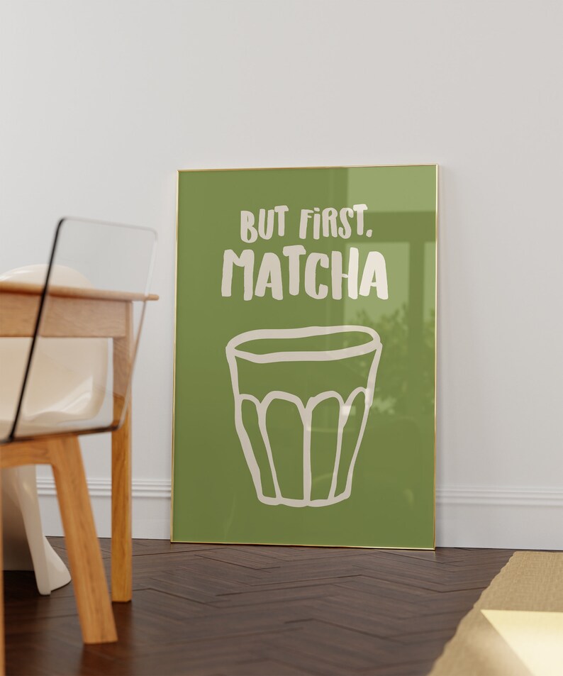 May include: A framed green poster with white text that reads "But first, matcha" and a white illustration of a cup of matcha.