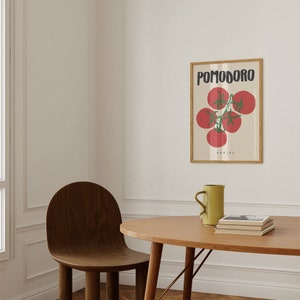 May include: A framed print with a white background and a drawing of red tomatoes on a vine. The text "POMODORO NAPLES" is printed below the tomatoes.