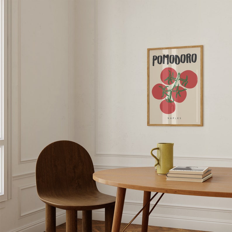 May include: A framed print with a white background and a drawing of red tomatoes on a vine. The text "POMODORO NAPLES" is printed below the tomatoes.