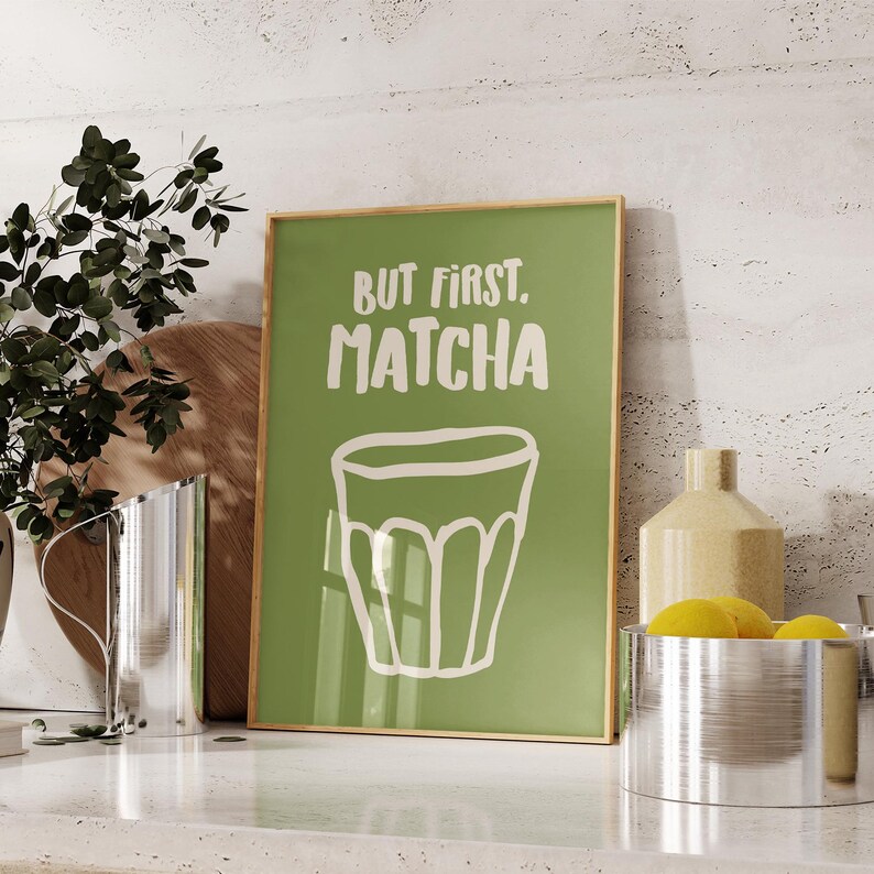 May include: A green and white poster with the text "But first, matcha" and a drawing of a cup of matcha.
