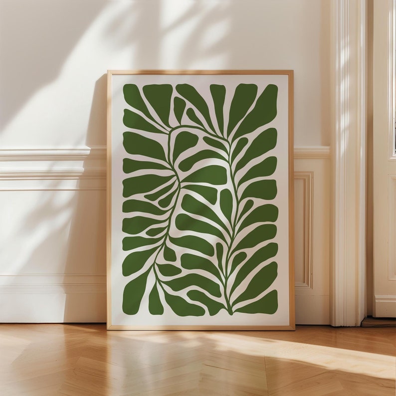 May include: A framed print of a stylised green leaf design. The leaf is depicted in a modern, abstract style with a white background.