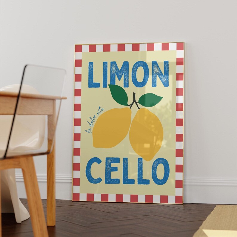 May include: A yellow and white poster with a red and white checkered border. The poster says "Limon Cello" in blue letters and features a drawing of two lemons with green leaves. The text "la dolce vita" is written in smaller blue letters.