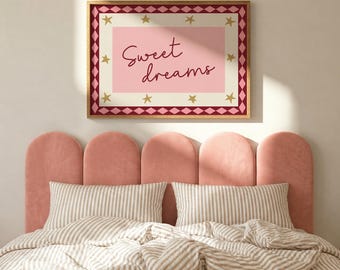 May include: A rectangular wall art print featuring the text Sweet dreams in dark red script on a light pink background. The print has a cream border with gold stars and a dark red and pink diamond pattern frame, all enclosed in a wooden frame.