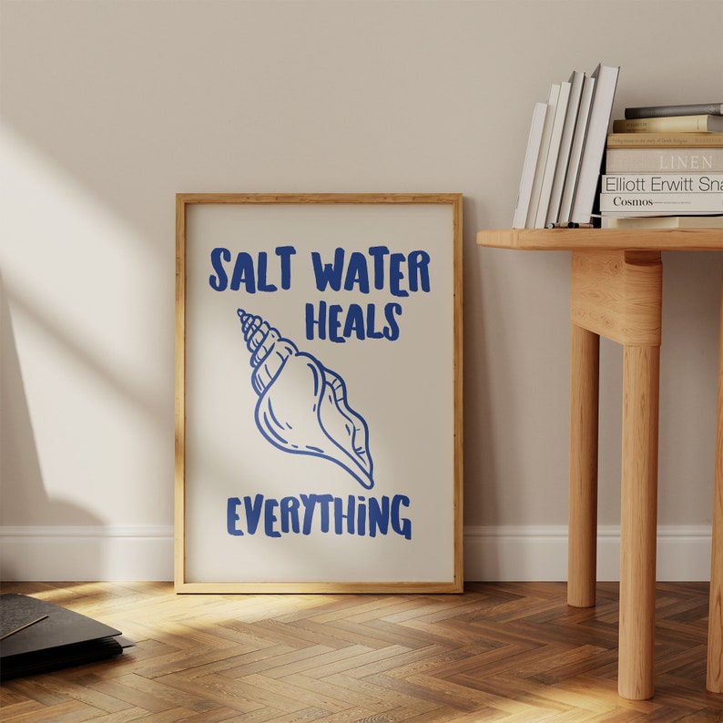 May include: A framed print with a blue seashell and the text "Salt Water Heals Everything".