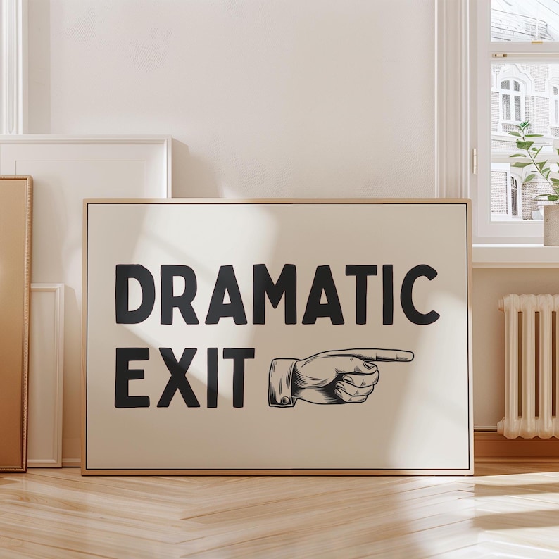 May include: A white canvas print with black text that reads "Dramatic Exit" and a black and white illustration of a hand pointing to the right.