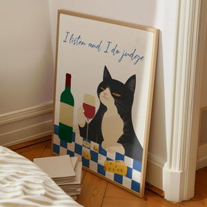 May include: A framed print with a black cat sitting at a checkered table with a glass of wine and a bottle of wine. The text on the print reads "I listen and I do judge".