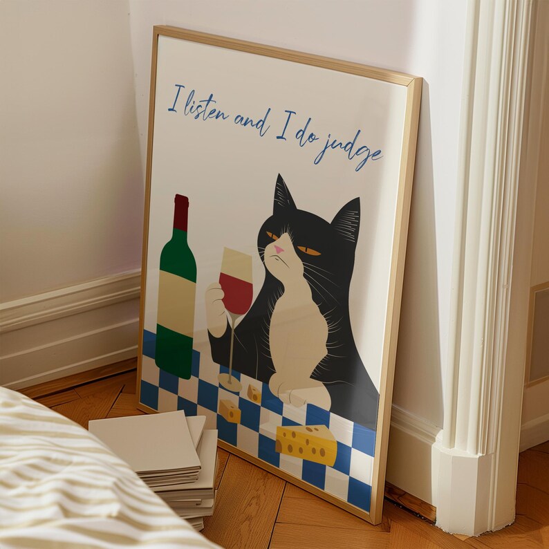 May include: A framed print with a black cat sitting at a checkered table with a glass of wine and a bottle of wine. The text on the print reads "I listen and I do judge".