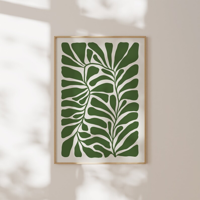 May include: A framed print of a stylised green leaf design on a white background.