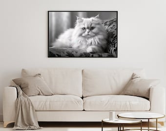 May include: A black and white photograph of a long-haired white cat sitting on a patterned couch. The cat is looking directly at the camera.