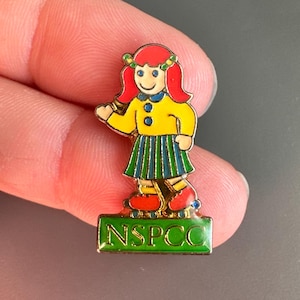 Waving young girl NSPCC charity cartoon character child enamel lapel pin badge brooch
