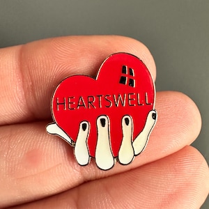 hand holding Love heart Heartswell enamel lapel pin badge brooch
