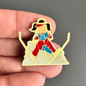 lady Ski jumping skiing reading book multitasking enamel lapel pin badge brooch