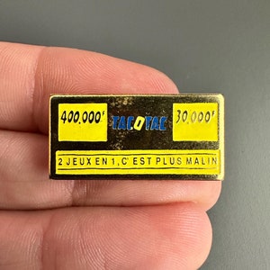 Broszka z emalią w odcieniu złota, konkurs na numer losu loterii FDJ Tac'o'Tac French FDJ