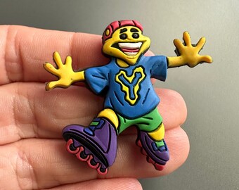 Könnte beinhalten: Eine gelbe, blaue, rote, grüne und violette Comicfigur auf Rollschuhen. Die Figur trägt einen roten Hut und ein blaues Shirt mit einem gelben Buchstaben Y darauf. Die Figur lächelt und hat die Arme ausgestreckt.