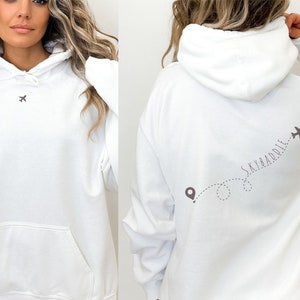 May include: White hoodie with a small airplane graphic on the front and the text "Skybaddle" with a larger airplane graphic and a dotted line on the back.