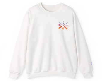 May include: White crewneck sweatshirt with a small, colorful graphic on the chest featuring crossed oars, a fish, a shovel, and a campfire. The graphic is in shades of blue, orange, and purple. The sweatshirt has long sleeves and a relaxed fit.