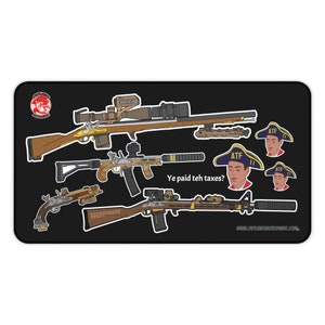 Può includere: Tappetino per mouse rettangolare nero con illustrazioni di armi da fuoco con accenti marroni e dorati. Il tappetino per mouse include il testo "Ye paid teh taxes?" e immagini di un uomo con un cappello a tricorno. Il logo Outlaws Worldwide è nell'angolo in alto a sinistra.