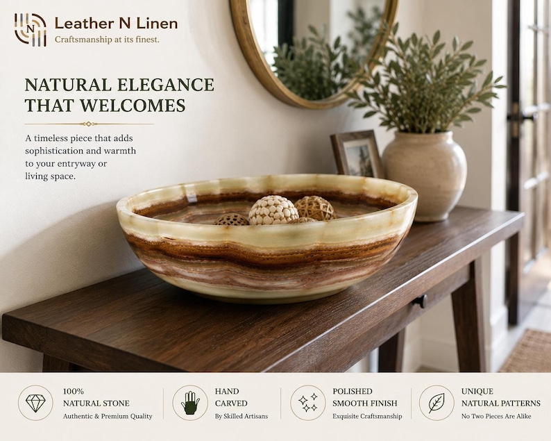 The decorative stone bowl filled with woven spheres rests on a dark wooden entryway console table beneath a round mirror and potted plant.