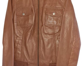 May include: A brown leather jacket with a zipper closure and two flap pockets. The jacket has a ribbed knit collar, cuffs, and waistband.
