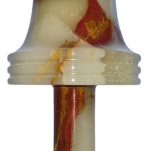 May include: A decorative onyx lamp with a flared top and a round base. The lamp features a cream and green color scheme with red and gold veining throughout. The lamp is approximately 7 inches tall.