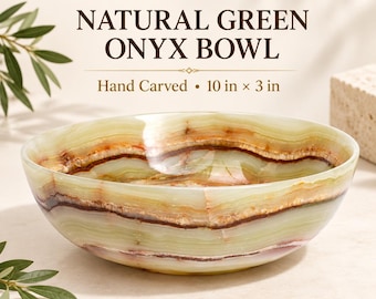 May include: A hand-carved natural green onyx bowl featuring horizontal bands of light green, cream, and dark brown mineral veining. The bowl has a smooth, polished finish and measures 10 inches in diameter by 3 inches in height as stated in text.