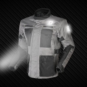 May include: Gray motorcycle jacket with black accents and multiple pockets. The jacket features reflective logos and trim, a high collar, and adjustable closures. The jacket is designed for protection and visibility.