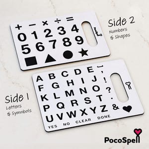 May include: Two white rectangular boards with black text and symbols. Side 1 features the alphabet, punctuation, and words YES, NO, CLEAR, DONE. Side 2 displays numbers 0-9, math symbols, and shapes including a square, triangle, circle, and star.