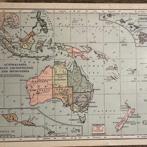 May include: A vintage map depicting Australasia, the Malay Archipelago, and Micronesia, with detailed geographical features. The map is coloured in muted tones of pink, green, and beige. Text includes place names and the title "Australasia, Malay Archipelago and Micronesia."