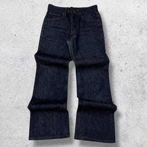 May include: Dark indigo denim jeans with a five-pocket design. These jeans feature a high waist and a wide leg, offering a retro aesthetic. The denim fabric looks robust and hard-wearing.
