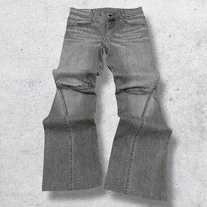 May include: Grey denim jeans with a flared leg design. The jeans have a classic five-pocket style, a button and zip closure, and visible stitching details. The fabric appears to be a medium-weight denim.