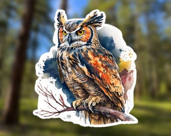 May include: A watercolor illustration of an owl with brown, orange, and white feathers perched on a branch. The owl has yellow eyes and a sharp beak. The background is a blurred watercolor wash of blue and green.