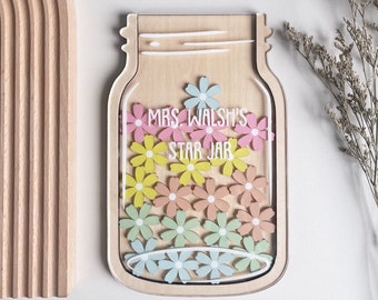 May include: A wooden cutout of a mason jar with a clear acrylic front. The jar is filled with colorful paper flowers and the text "Mrs. Walsh's Star Jar" is written on the front.
