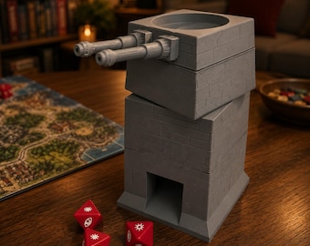 May include: A gray, 3D-printed dice tower with a fortress design, featuring two cannon-like protrusions. Three red dice with white symbols are scattered nearby. The tower has a rectangular base and a circular top, suitable for tabletop gaming.