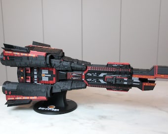 May include: A black and red spaceship model with orange accents. The model is on a black stand with the word "CONVERGER" printed on it.