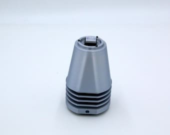May include: A gray, 3D-printed object with a conical shape and a ridged base. The top has a square opening. The object is set against a white background.