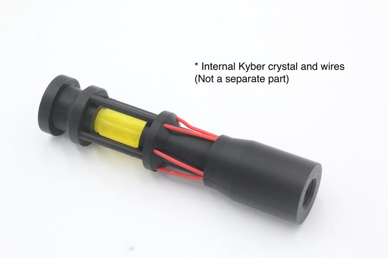 May include: A black cylindrical component featuring a yellow Kyber crystal encased within a cage-like structure, accented by thin red wires extending along the body. The text reads: * Internal Kyber crystal and wires (Not a separate part).