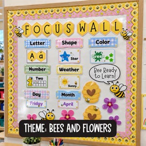 Könnte beinhalten: Eine Klassenzimmer-Pinnwand mit einem Bienen- und Blumenrand und der Aufschrift FOCUS WALL. Sie enthält pädagogische Beschriftungen für Buchstaben, Formen, Farben, Zahlen, Wetter, Tage und Monate mit passenden Symbolen wie Bienen und Blumen.