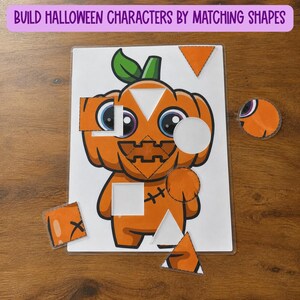 May include: A laminated activity sheet featuring a cartoon pumpkin character with cut-out shapes for matching. The text at the top reads BUILD HALLOWEEN CHARACTERS BY MATCHING SHAPES. Several orange geometric pieces are placed around the central figure.