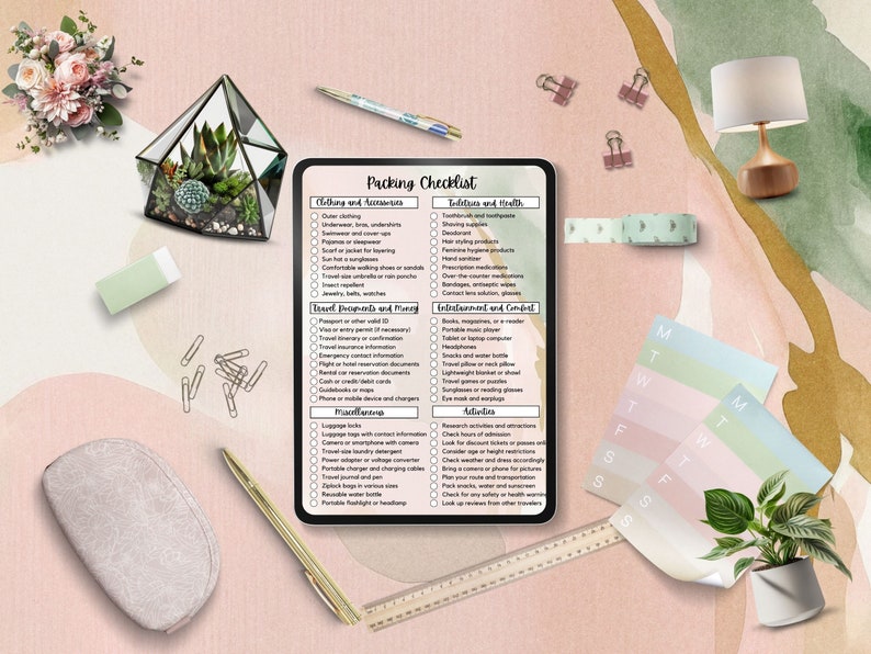 May include: A digital tablet displaying a packing checklist for travel. The checklist includes categories for clothing and accessories, toiletries and health, travel documents and money, entertainment and comfort, activities, and miscellaneous. The tablet is on a pink and green background with a variety of decorative items.