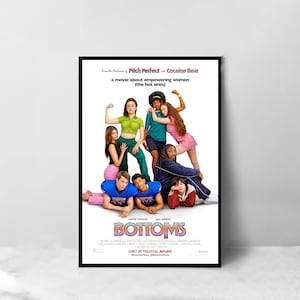 May include: Movie poster for the comedy film "Bottoms" featuring a group of young women and men in various poses. The poster has a white background with the title "Bottoms" in large, bold letters. The text "From the Producers of Pitch Perfect and Cocaine Bear" is at the top of the poster, and the text "a movie about empowering women (the hot ones)" is below the title.