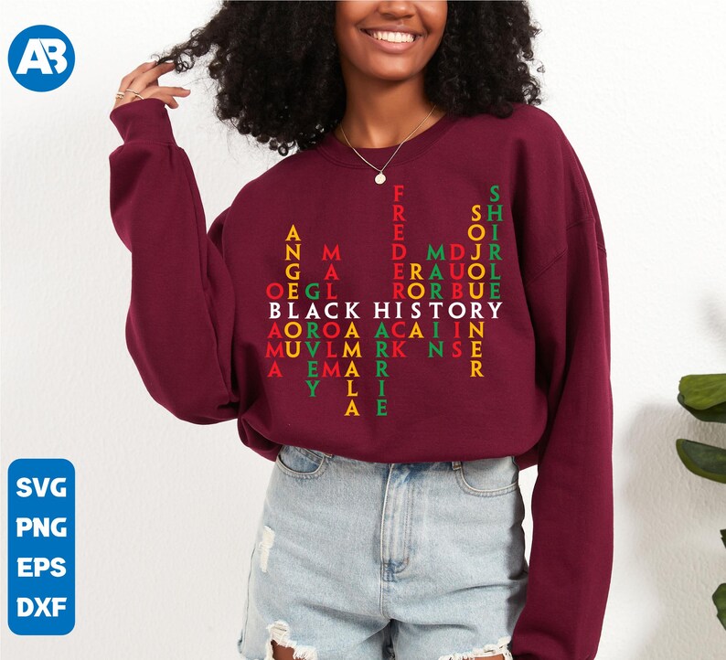 May include: A maroon sweatshirt featuring a red, green and yellow design that spells out "Black History" in a word search puzzle. The design includes names such as "Frederick Douglass", "Martin Luther King Jr." and "Angela Davis".