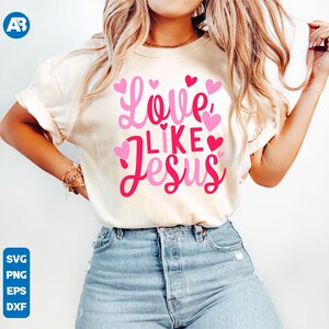 May include: A white t-shirt with the text "Love Like Jesus" in pink lettering and pink hearts.