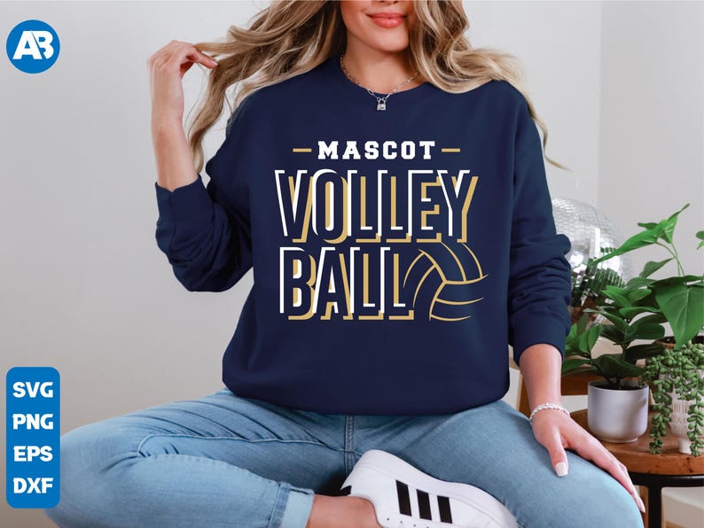 May include: A navy blue sweatshirt with the text "MASCOT VOLLEYBALL" in gold and white lettering. A gold volleyball graphic is to the right of the text.