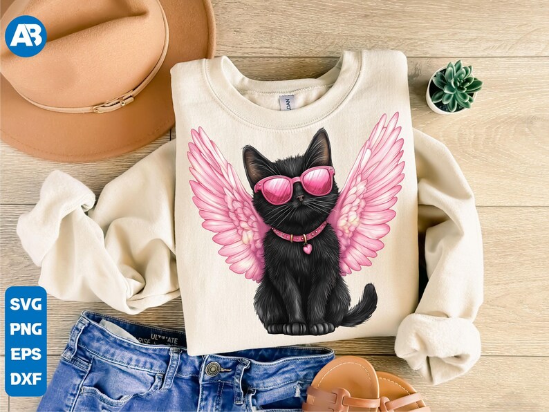 May include: A black cat with pink angel wings and pink sunglasses is wearing a silver collar with a heart charm. The cat is sitting on a cream colored sweatshirt.