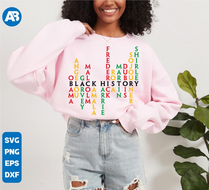 May include: A pink sweatshirt featuring a black, red, green and yellow word puzzle that reads "Black History" in the centre. The puzzle is made up of names of significant African American figures.