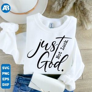 May include: White sweatshirt with black text that reads "just God. Not Luck."
