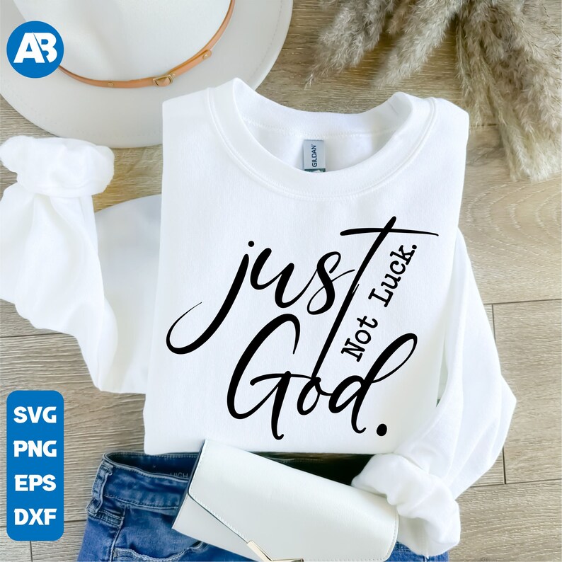 May include: White sweatshirt with black text that reads "just God. Not Luck."