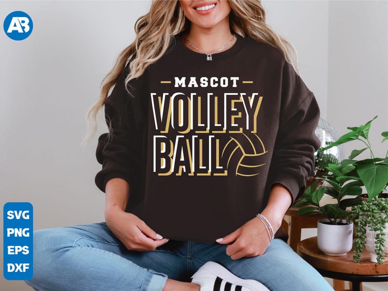 May include: A brown sweatshirt with the text "MASCOT VOLLEYBALL" in white and gold lettering. A volleyball graphic is included in the design.