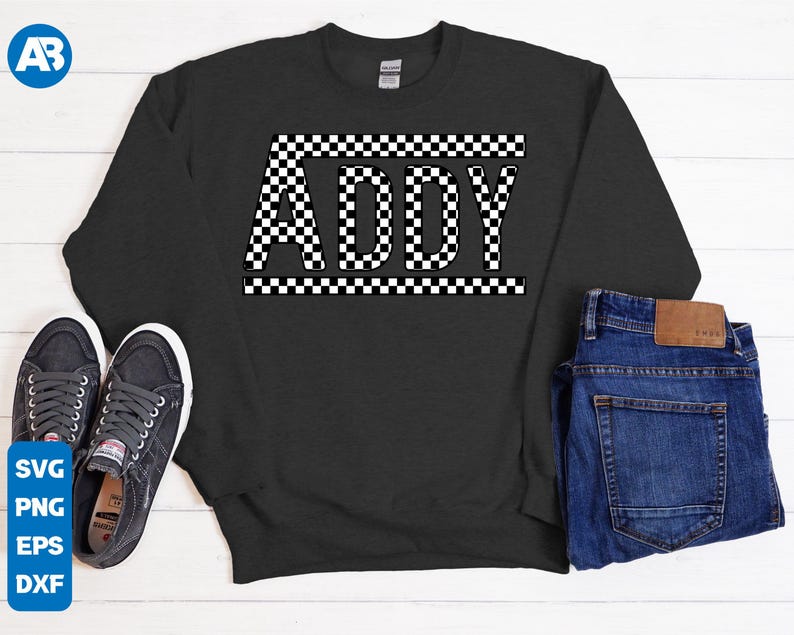 May include: A dark gray sweatshirt with the name "ADDY" printed in white letters on a black and white checkered background.